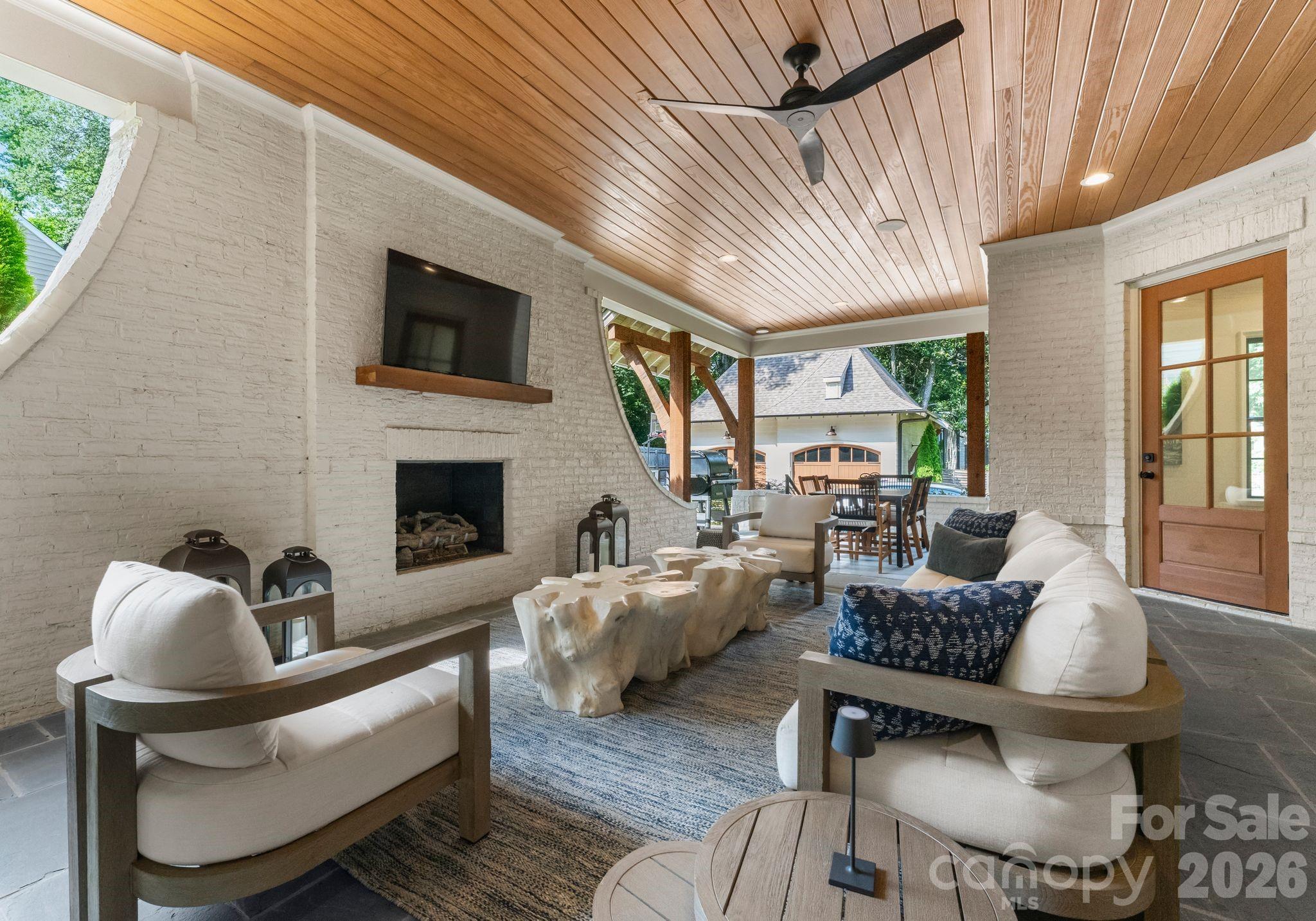 5625 Timber Lane Charlotte, NC 28270 - Photo 46 of 48 a living room with furniture a fireplace and a large window