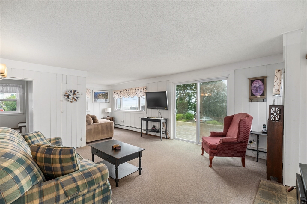 63 North Ridge Road Ipswich, MA 01938 - Photo 11 of 28 a living room with furniture a flat screen tv and a fireplace