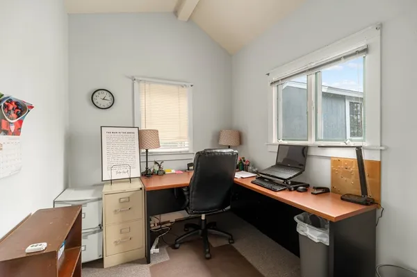 a view of workspace with wooden floor windows