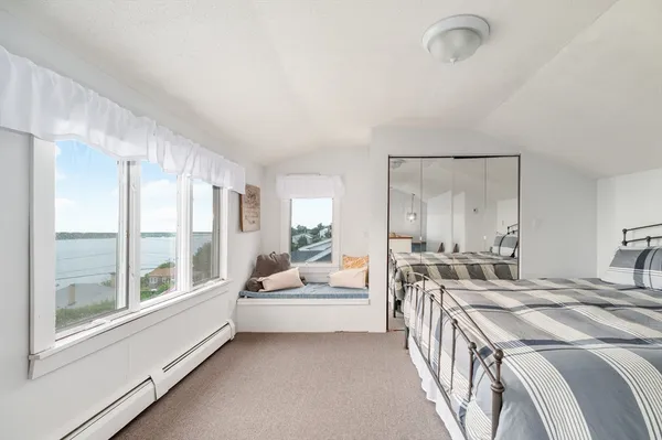 a spacious bedroom with a bed and a large window