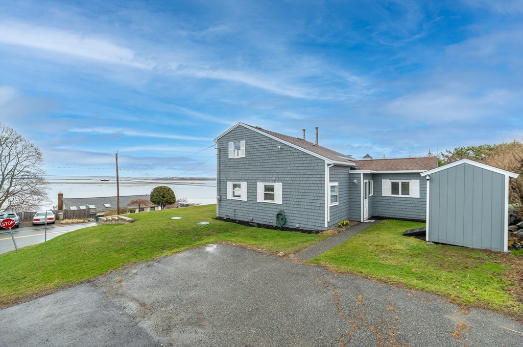 63 North Ridge Road Ipswich, MA 01938 - Photo 24 of 28 a backyard of a house with table and chairs