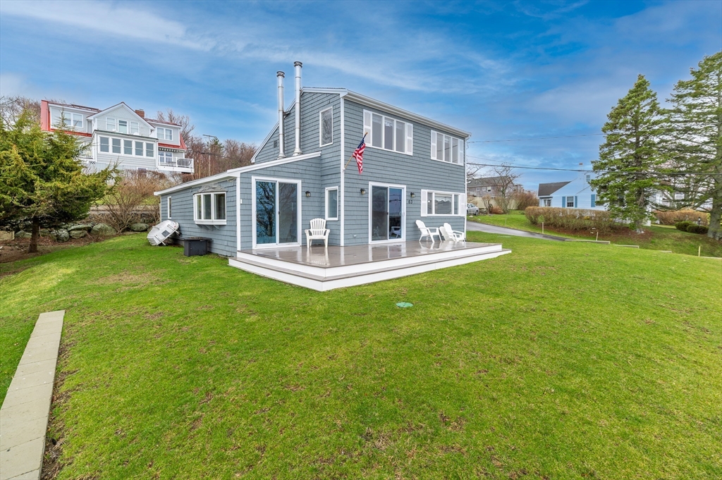 63 North Ridge Road Ipswich, MA 01938 - Photo 6 of 28 a front view of a house with a yard table and chairs