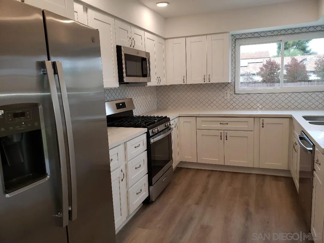 1859 Rees Road San Marcos, CA 92069 - Photo 4 of 11 a kitchen with a sink microwave and refrigerator
