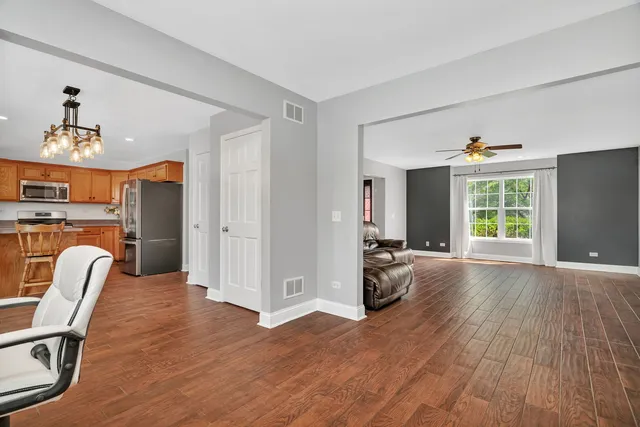a view of kitchen with microwave and cabinets