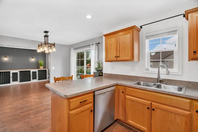 a kitchen with stainless steel appliances a refrigerator and a stove top oven