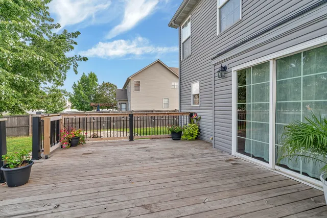 a backyard of a house with table and chairs
