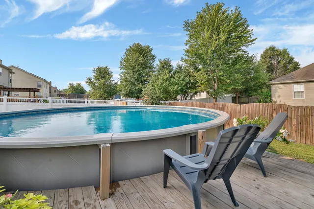 a view of a wooden deck and a backyard
