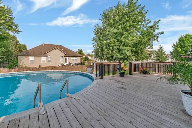 a view of a wooden deck and a backyard