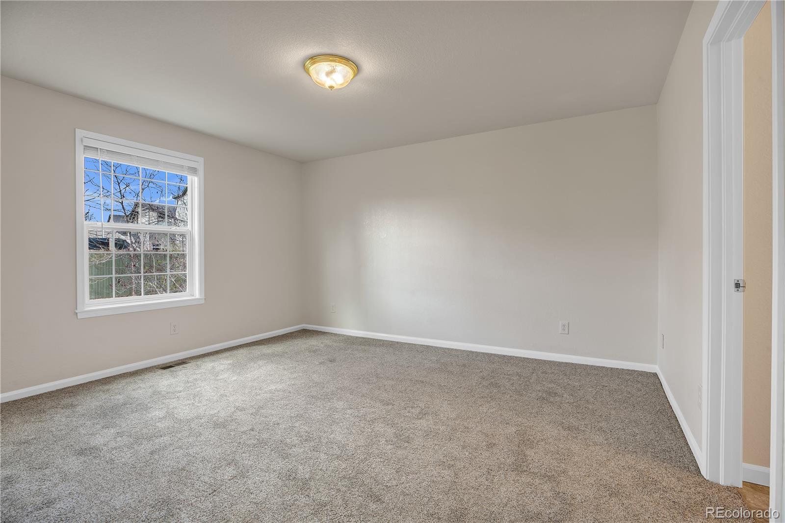 4505 Simms Court Wheat Ridge, CO 80033 - Photo 19 of 37 an empty room with windows