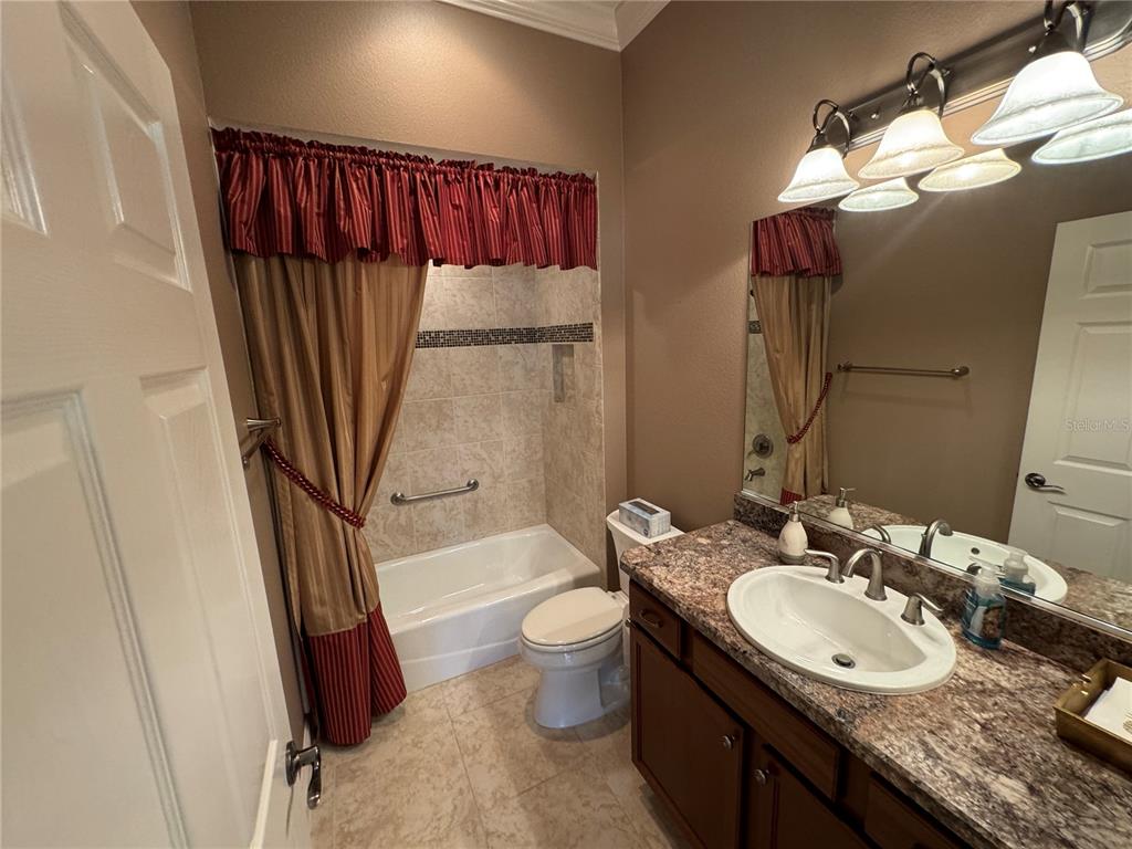 2276 Fringe Tree Trail The Villages, FL 32162 - Photo 13 of 22 a bathroom with a granite countertop sink toilet and shower
