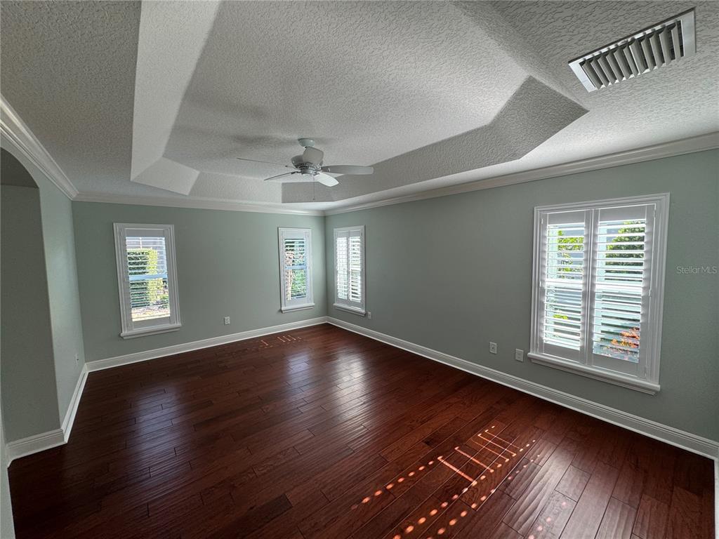 2276 Fringe Tree Trail The Villages, FL 32162 - Photo 14 of 22 a view of an empty room with wooden floor and a window