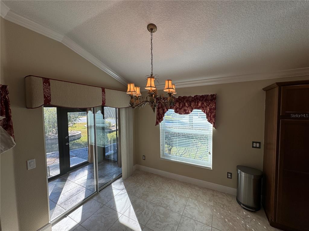 2276 Fringe Tree Trail The Villages, FL 32162 - Photo 5 of 22 a view of a hallway with windows and chandelier