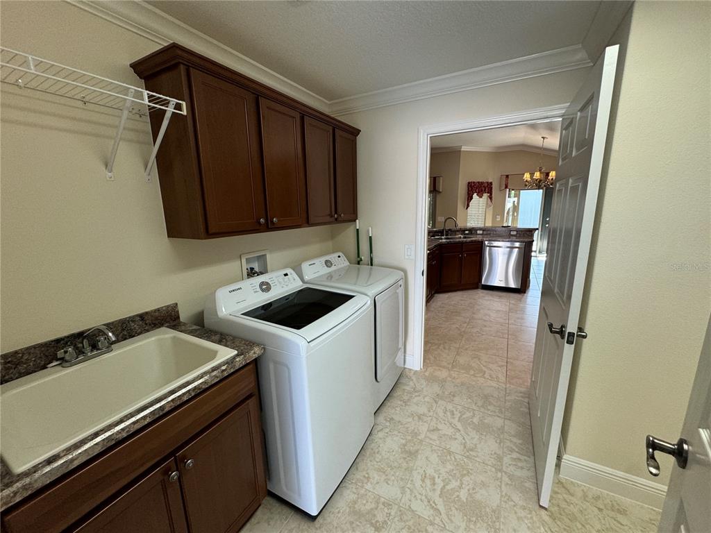 2276 Fringe Tree Trail The Villages, FL 32162 - Photo 7 of 22 a utility room with sink dryer and washer