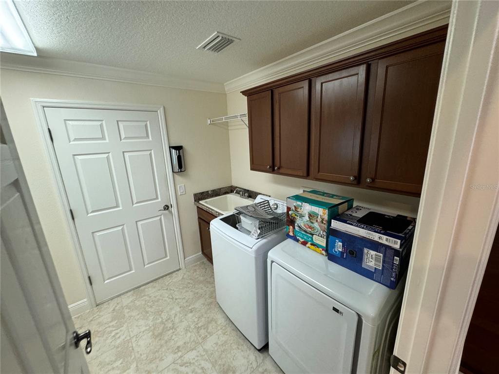 2276 Fringe Tree Trail The Villages, FL 32162 - Photo 8 of 22 a utility room with dryer and washer