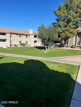 a front view of a house with a big yard