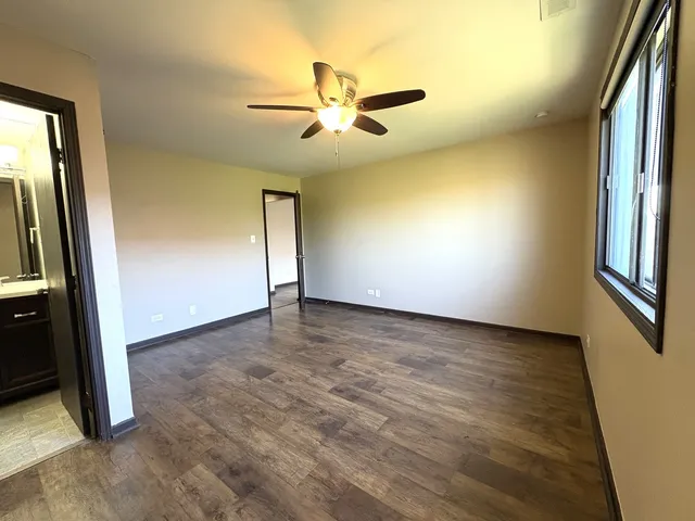 an empty room with windows and entrance