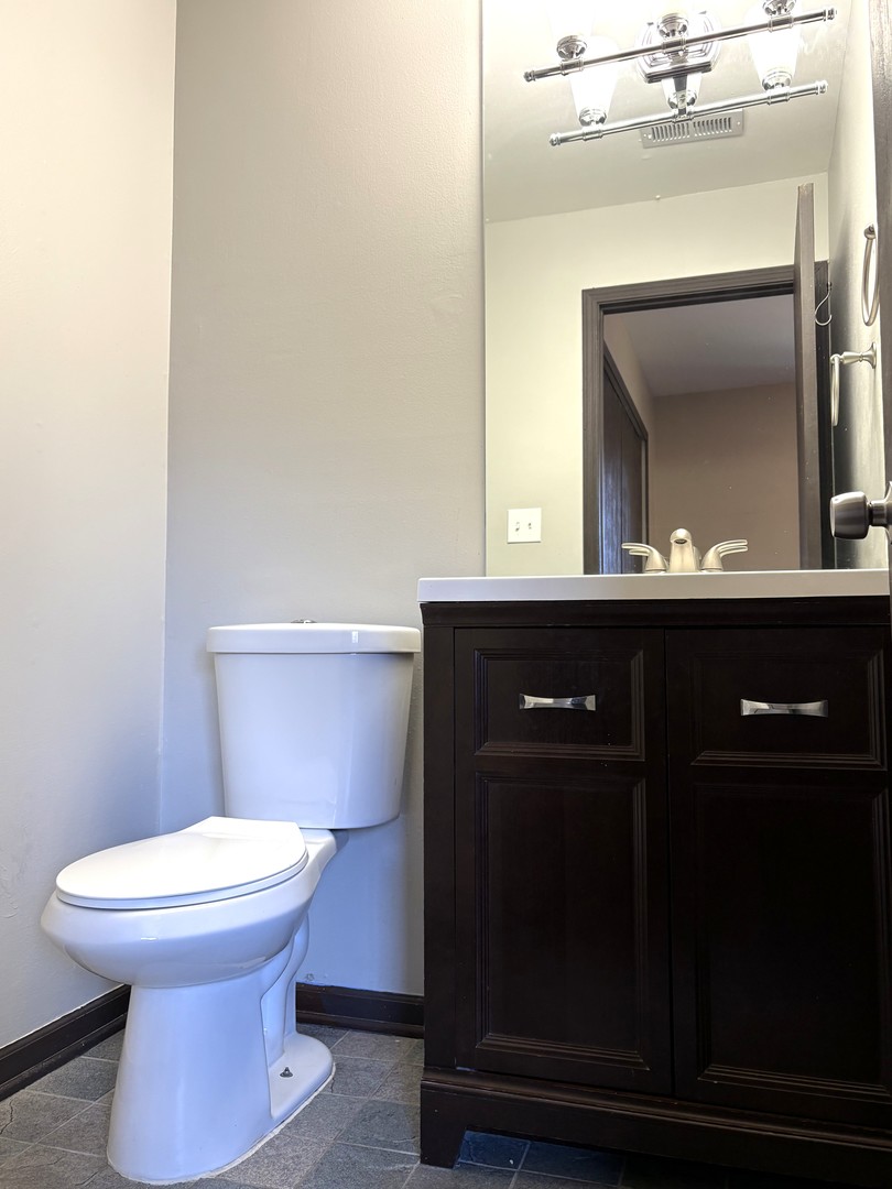 15805 Peggy Lane, Unit 9 Oak Forest, IL 60452 - Photo 14 of 20 a bathroom with a toilet mirror and vanity