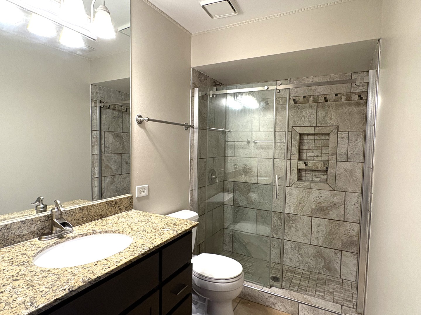 15805 Peggy Lane, Unit 9 Oak Forest, IL 60452 - Photo 15 of 20 a bathroom with a granite countertop sink toilet and shower