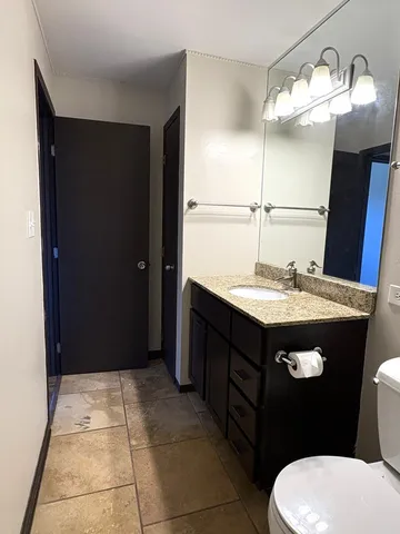 a bathroom with a sink vanity and a mirror