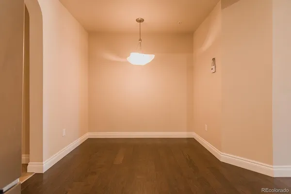 a view of a room with wooden floor and window