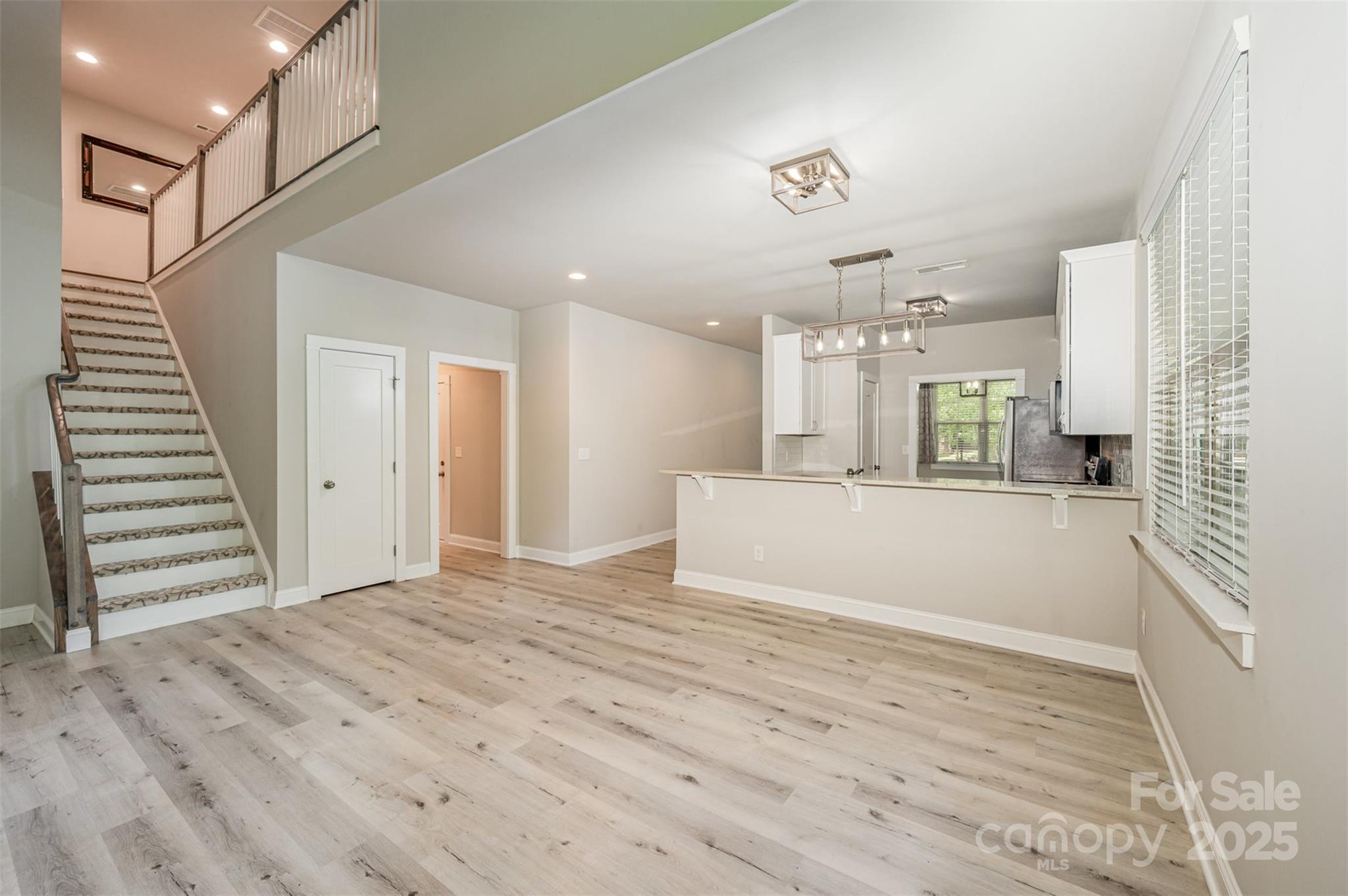 3004 Village Ridge Drive Gastonia, NC 28056 - Photo 11 of 35 a view of a kitchen with wooden cabinet and staircase
