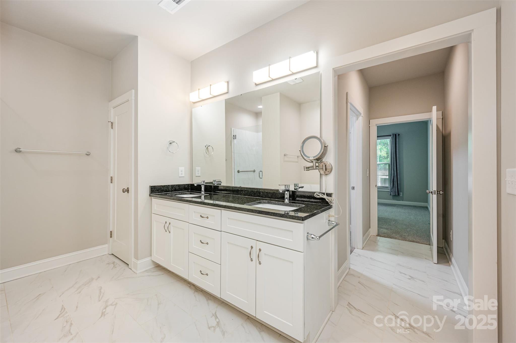 3004 Village Ridge Drive Gastonia, NC 28056 - Photo 17 of 35 a spacious bathroom with a granite countertop sink and a mirror