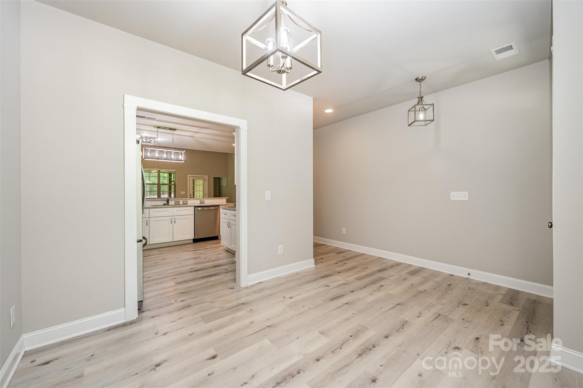3004 Village Ridge Drive Gastonia, NC 28056 - Photo 5 of 35 wooden floor in an empty room and a kitchen