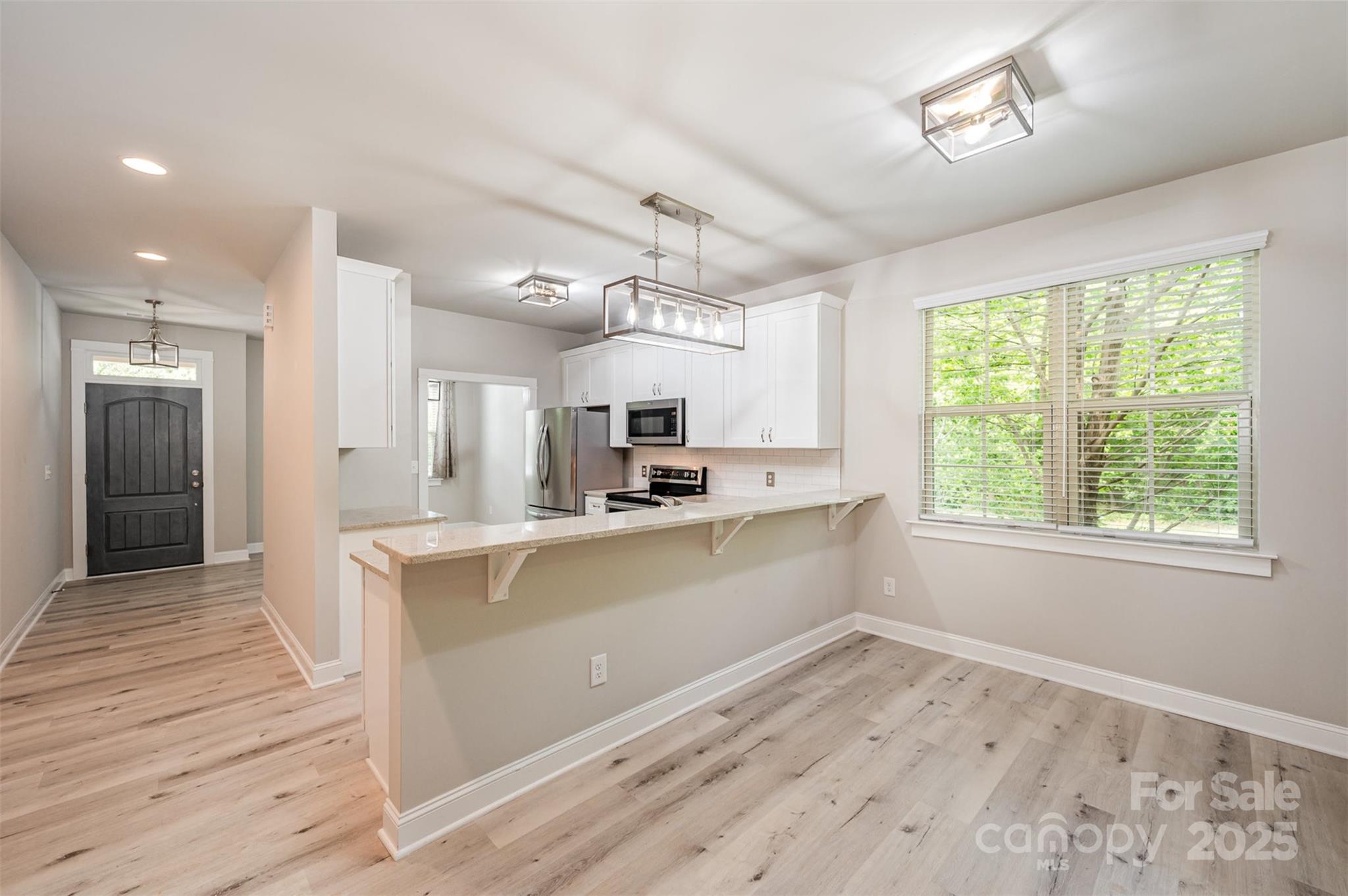 3004 Village Ridge Drive Gastonia, NC 28056 - Photo 6 of 35 a large kitchen with kitchen island a large counter space a sink appliances and cabinets