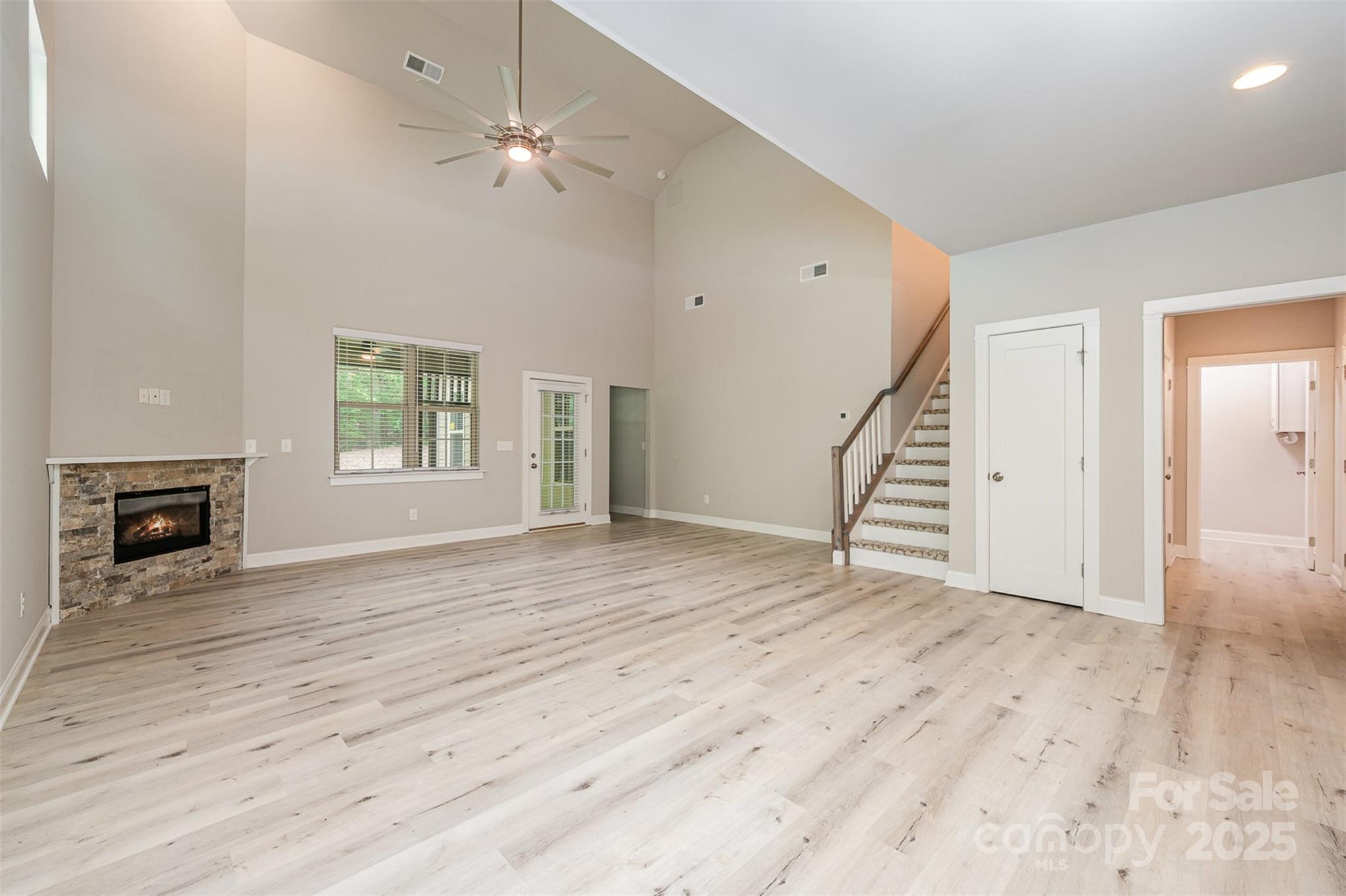 3004 Village Ridge Drive Gastonia, NC 28056 - Photo 9 of 35 an empty room with wooden floor fireplace and windows