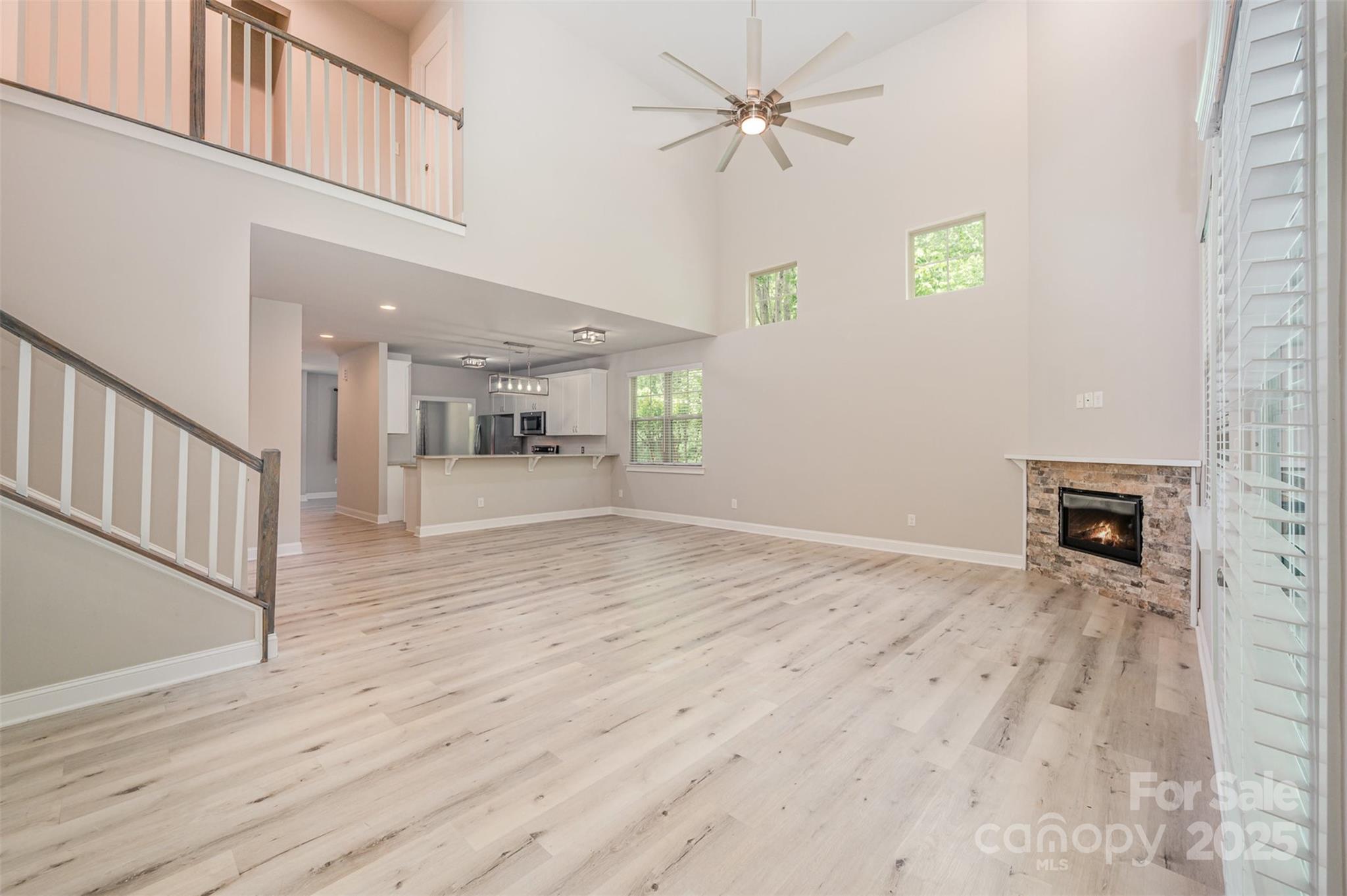 3004 Village Ridge Drive Gastonia, NC 28056 - Photo 10 of 35 a view of a livingroom with wooden floor and a ceiling fan