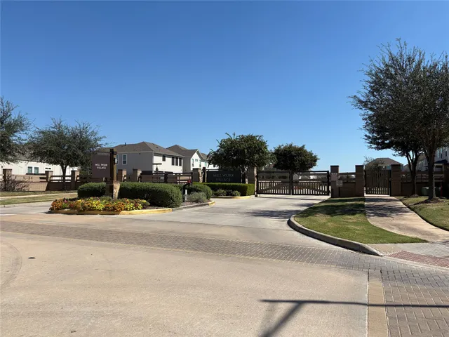 a view of a hallway with wooden floor and furniture