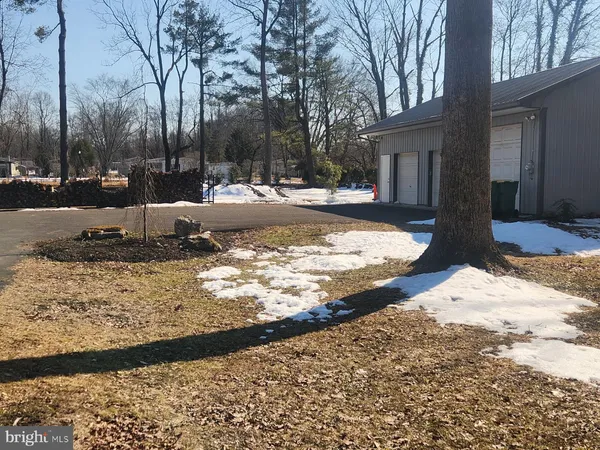 a view of a yard with snow on the road