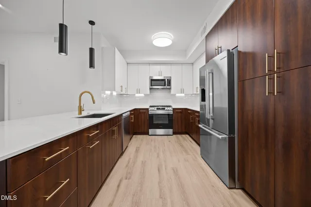 a large kitchen with a large window and stainless steel appliances