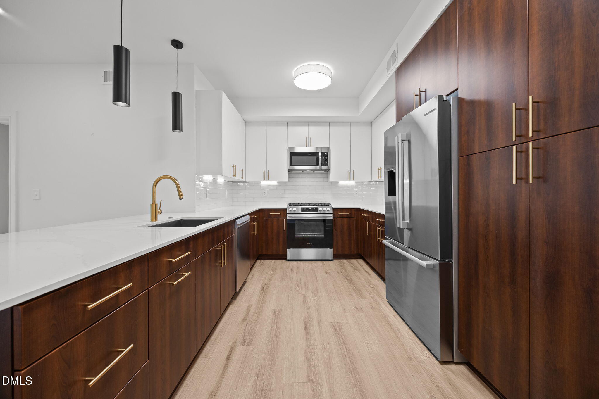 a large kitchen with a large window and stainless steel appliances