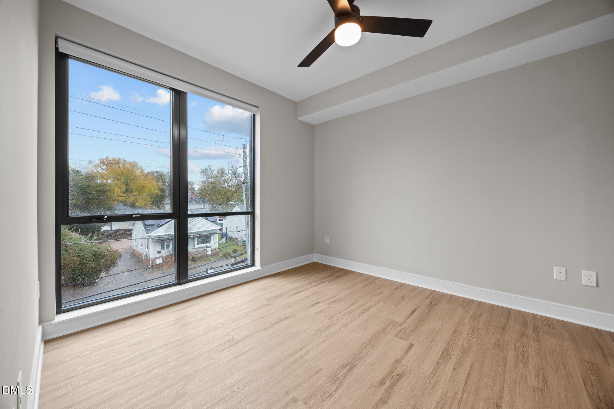 615 West Peace Street, Unit 307 Raleigh, NC 27605 - Photo 12 of 20 an empty room with wooden floor and windows