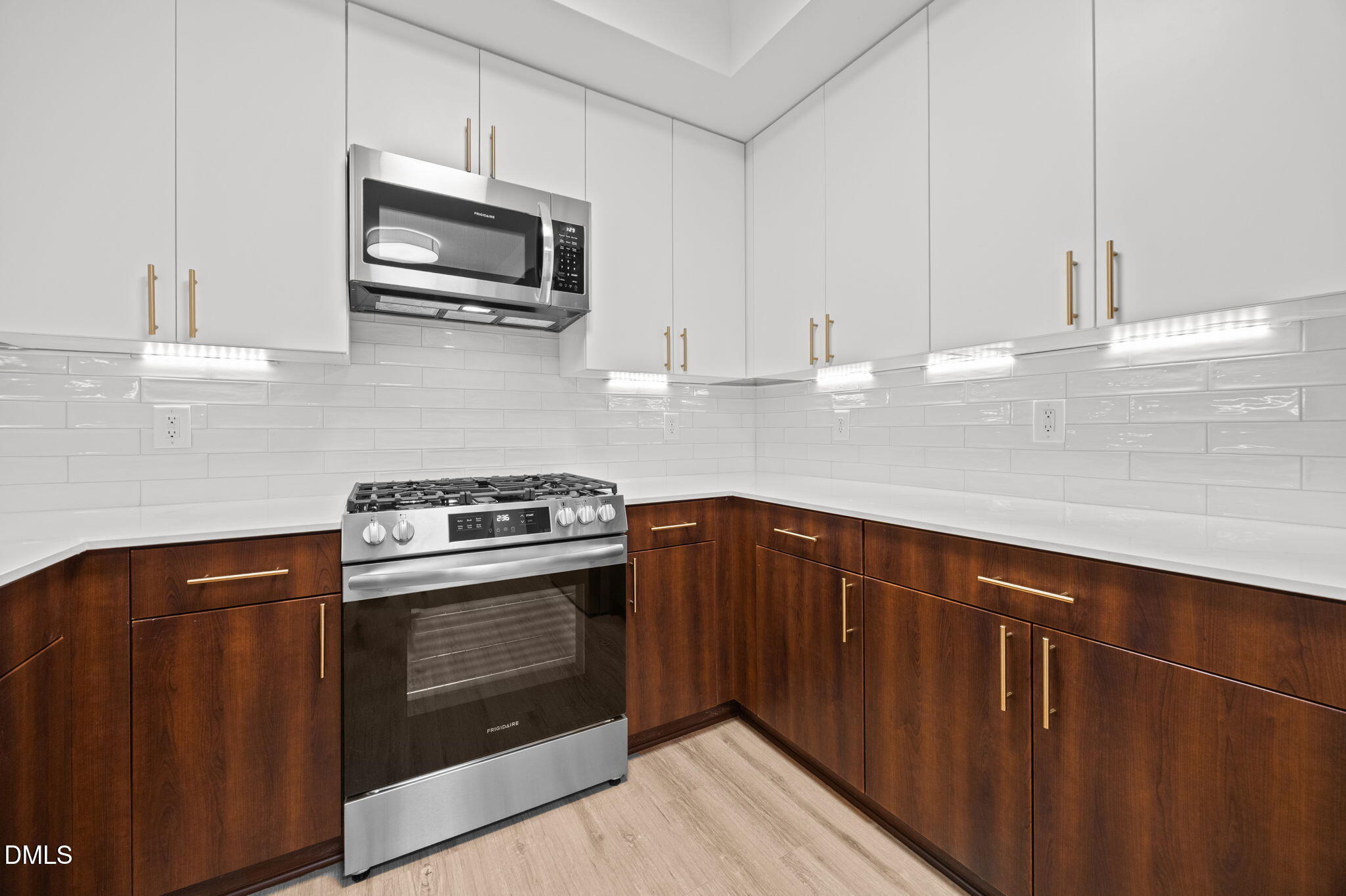 615 West Peace Street, Unit 307 Raleigh, NC 27605 - Photo 3 of 20 a kitchen with stainless steel appliances a stove microwave and cabinets