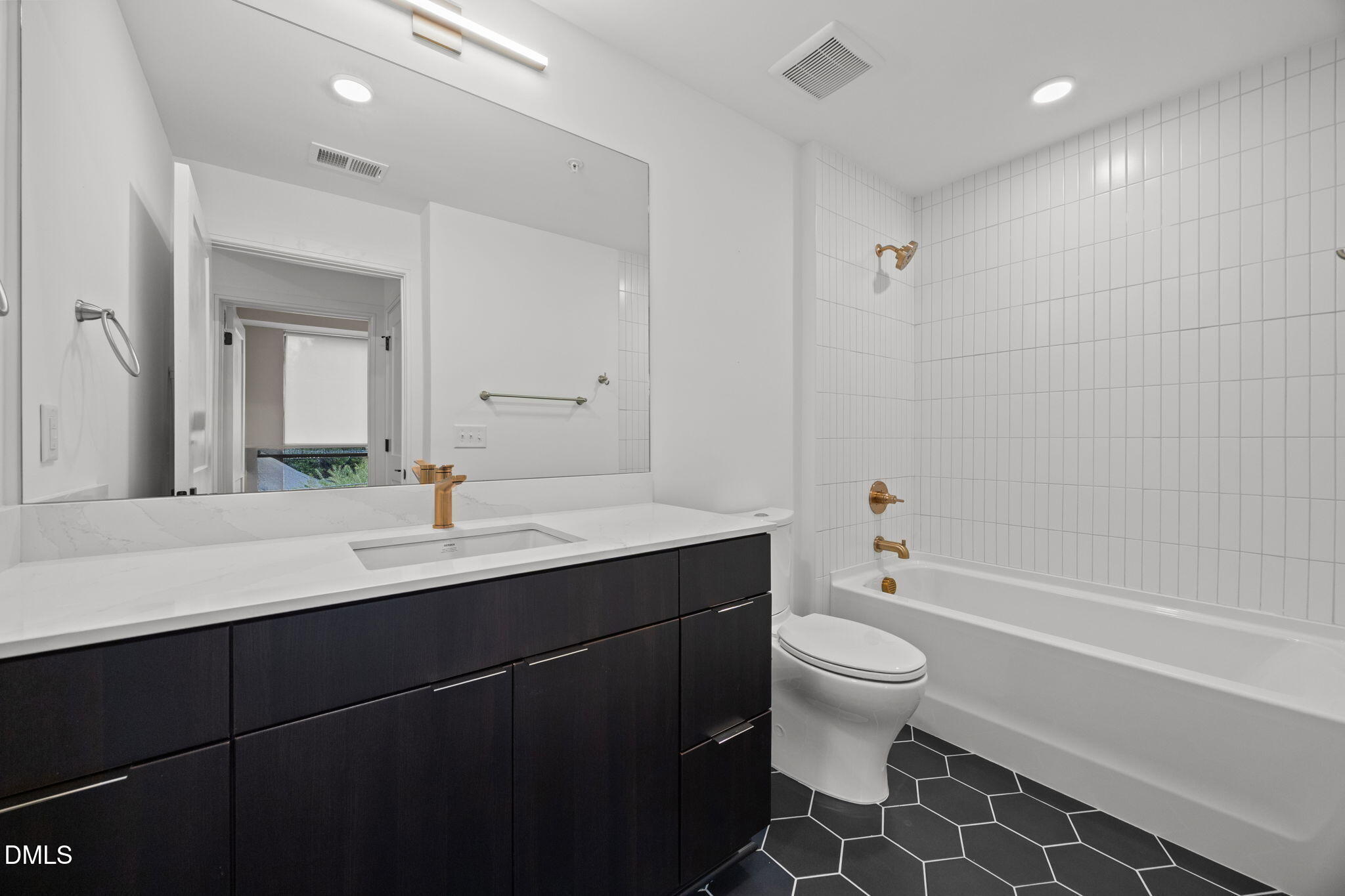 615 West Peace Street, Unit 307 Raleigh, NC 27605 - Photo 8 of 20 a bathroom with a sink a toilet and a mirror