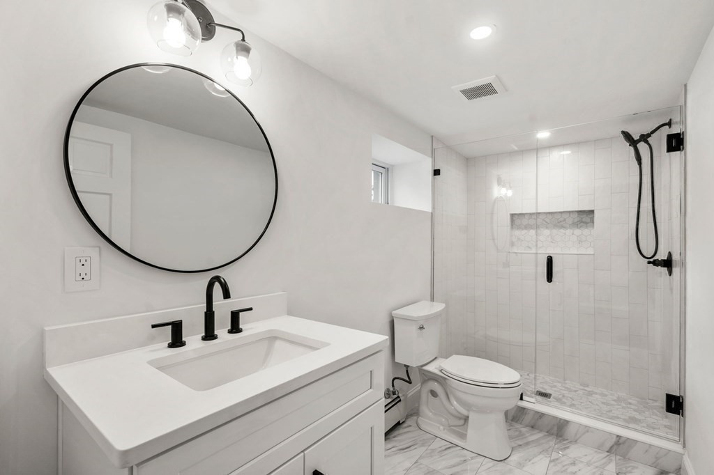 200 Hunting Road Needham, MA 02494 - Photo 19 of 31 a bathroom with a sink a toilet and a mirror