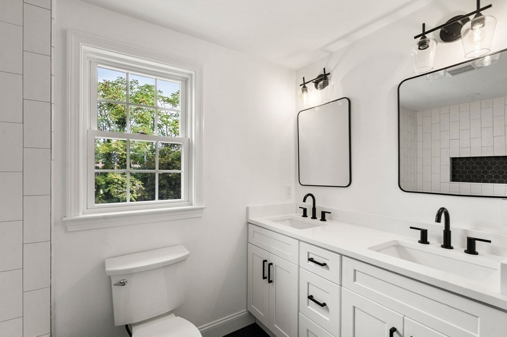 200 Hunting Road Needham, MA 02494 - Photo 20 of 31 a bathroom with double vanity sink a mirror and a toilet