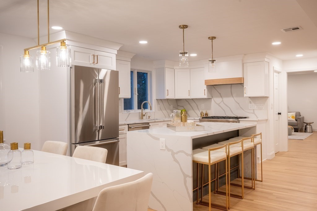 200 Hunting Road Needham, MA 02494 - Photo 6 of 31 a kitchen with stainless steel appliances granite countertop a sink refrigerator and cabinets
