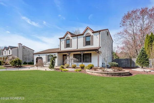 a front view of a building with a yard