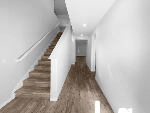 a view of entryway and gallery with wooden floor