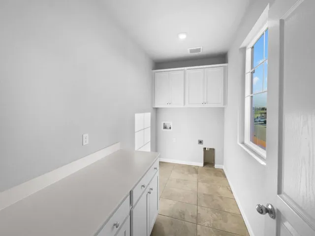 a view of a kitchen with wooden floor and windows