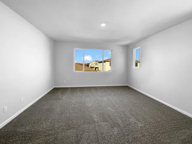 a view of an empty room and a window