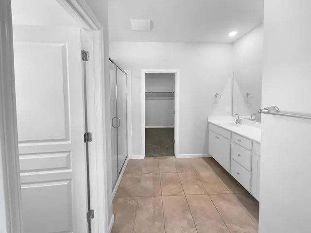 a spacious bathroom with a mirror sink and shower