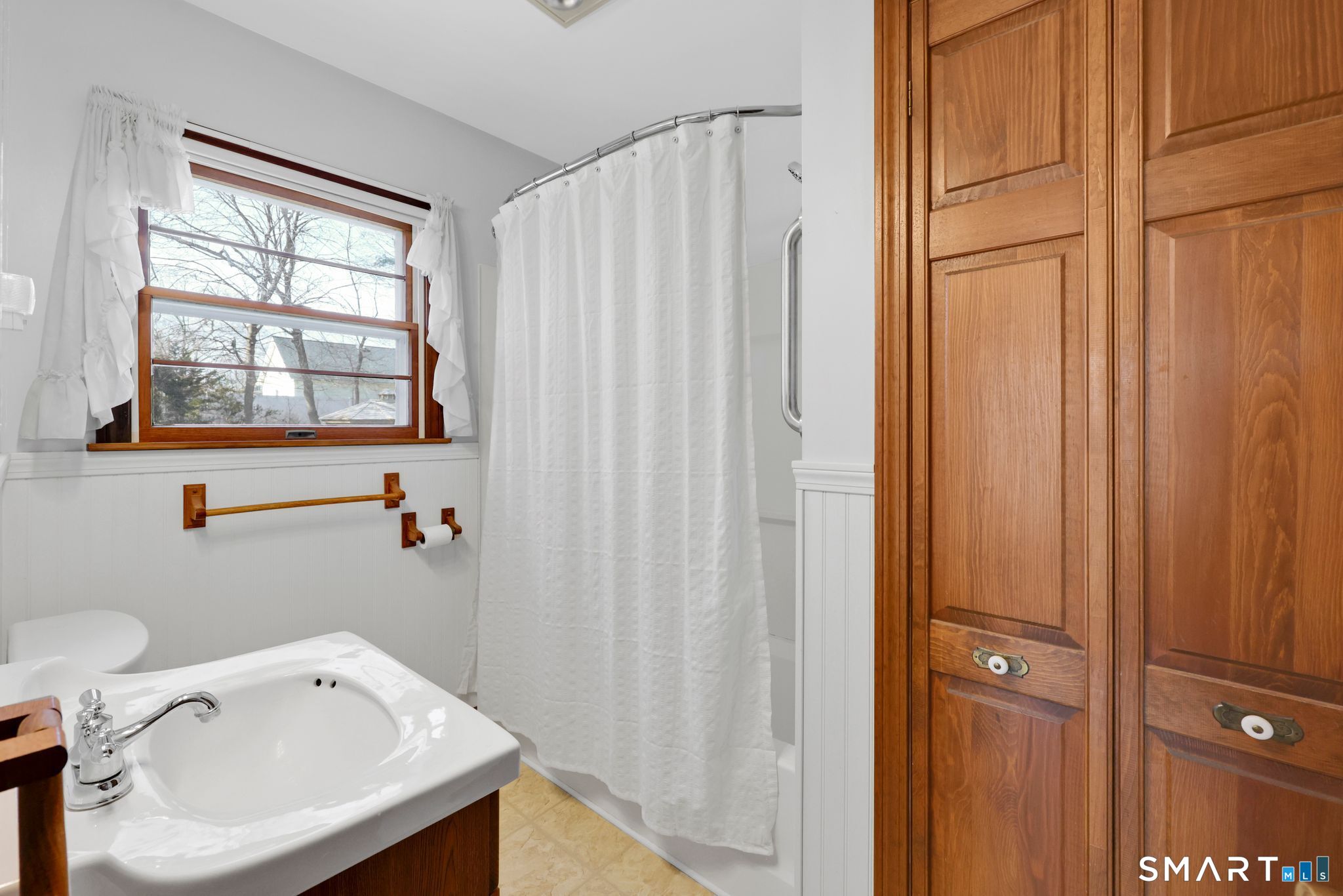 15 Johnson Road Wallingford, CT 06492 - Photo 20 of 37 a bathroom with a sink a toilet and a window