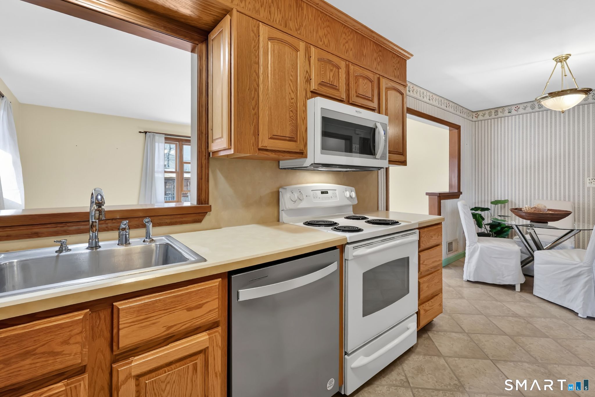 15 Johnson Road Wallingford, CT 06492 - Photo 8 of 37 a kitchen with stainless steel appliances granite countertop a sink stove and microwave