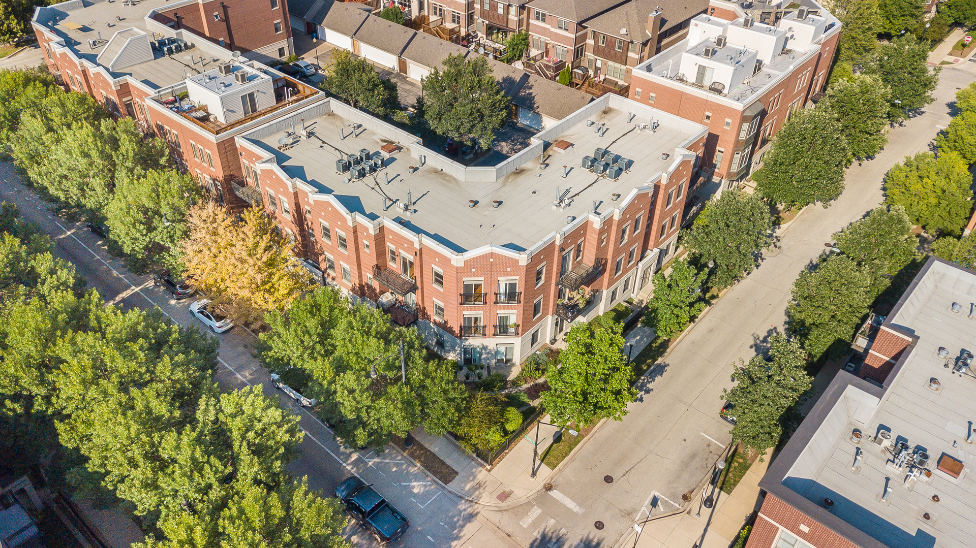 1461 South Halsted Street, Unit 3B Chicago, IL 60607 - Photo 19 of 21 an aerial view of a multi story residential apartment building with a yard