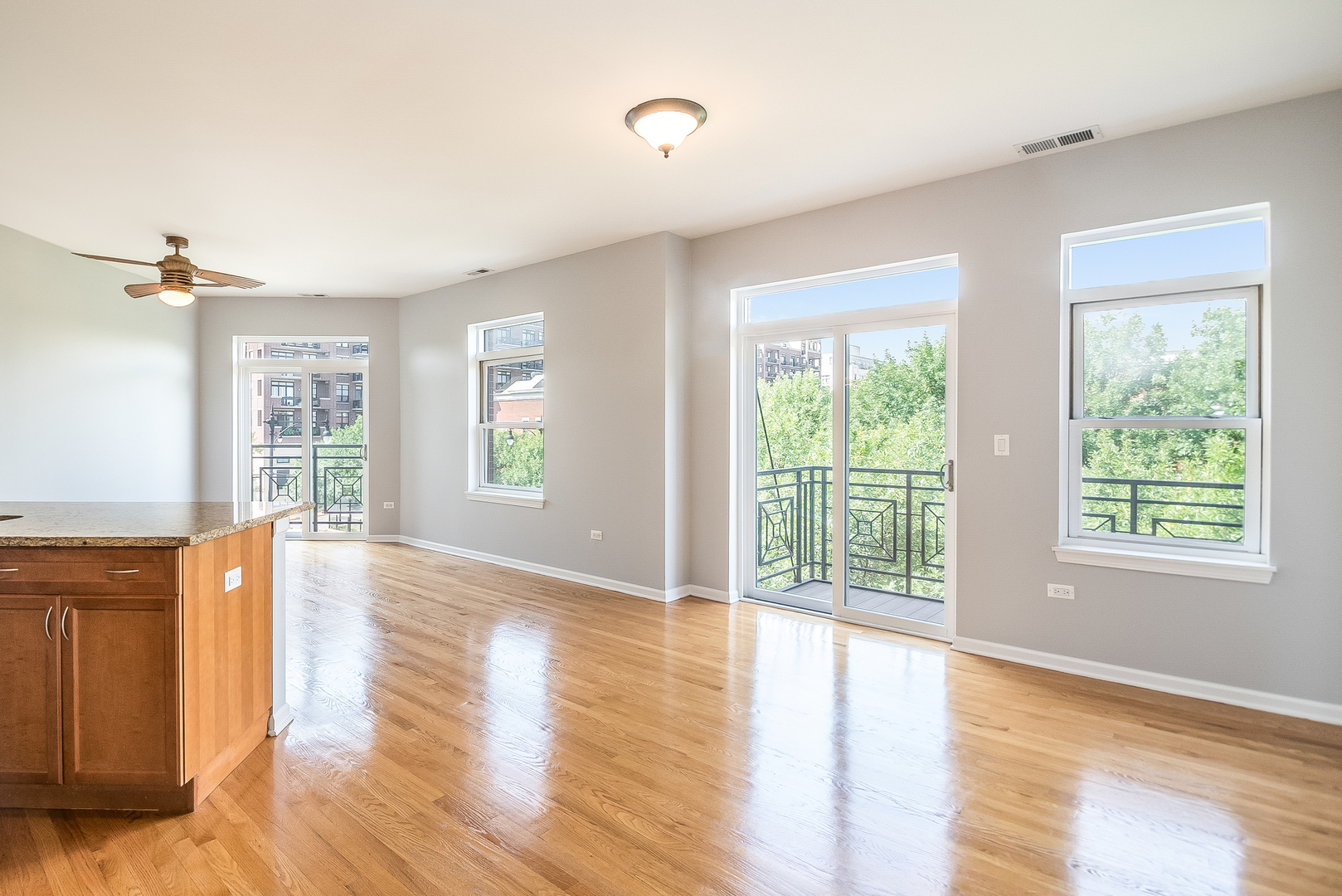 1461 South Halsted Street, Unit 3B Chicago, IL 60607 - Photo 3 of 21 a view of an empty room with wooden floor and a window