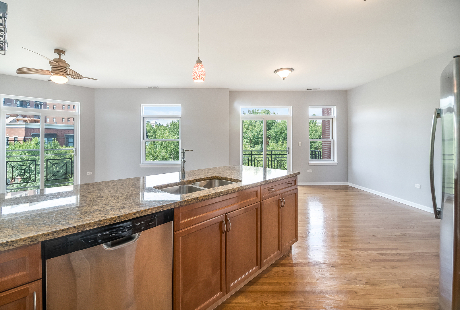 1461 South Halsted Street, Unit 3B Chicago, IL 60607 - Photo 8 of 21 a kitchen with stainless steel appliances granite countertop a sink a stove and a wooden floors
